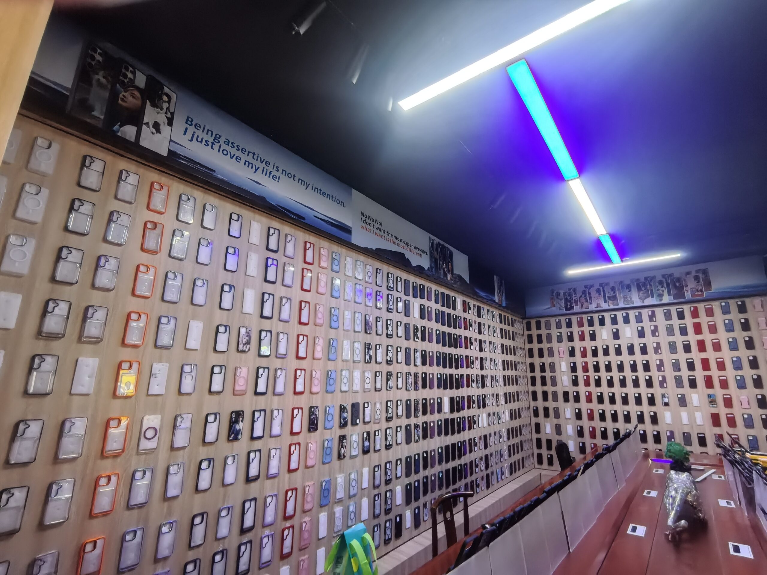 Display showing different phone case design options with pricing